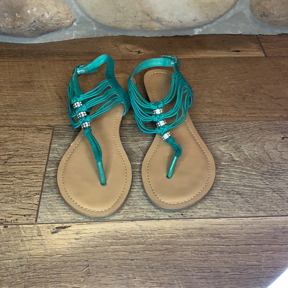 Green flat sandals.